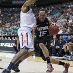 Harvard's Christian Webster, right, drives into Arizona's Kevin Parrom in the first half during a third-round game in the NCAA men's college basketball tournament in Salt Lake City on Saturday, March 23, 2013. (AP Photo/George Frey)

