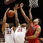 Stanford forward Dwight Powell (33) grabs a rebound next to teammate Josh Huestis (24) and Arizona forward Aaron Gordon (11) during the first half of an NCAA college basketball game on Wednesday, Jan. 29, 2014, in Stanford, Calif. (AP Photo/Marcio Jose Sanchez)
