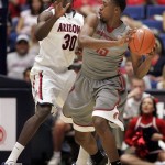 Washington State's Junior Longrus (15) looks to pass as Arizona's Angelo Chol (30) defemds during the first half of an NCAA college basketball game at McKale Center in Tucson, Ariz., Saturday, Feb. 23, 2013. (AP Photo/John Miller)
