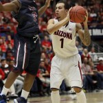 Arizona's Gabe York (1) looks to pass the ball around Fairleigh Dickinson's Malachi Nix (2) in the second half of an NCAA college basketball game, Monday, Nov. 18, 2013 in Tucson, Ariz. This is in the first round of the Preseason NIT. Arizona won 100 - 50. (AP Photo/Wily Low)