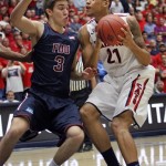 Arizona's Brandon Ashley (21) struggles with Fairleigh Dickinson's Matt MacDonald (3) in the first half of an college NCAA basketball game, Monday, Nov. 18, 2013 in Tucson, Ariz. This is in the first round of the Preseason NIT. (AP Photo/John Miller)