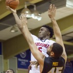 Arizona forward Stanley Johnson (5) slides past Missouri forward Keanau Post (45) to shoot a layup in the first half of an NCAA college basketball game at the Maui Invitational on Monday, Nov. 24, 2014, in Lahaina, Hawaii. (AP Photo/Eugene Tanner)