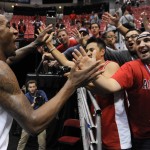 Arizona forward Rondae Hollis-Jefferson, left, reacts with fans after beating Gonzaga in a third-round game during the NCAA college basketball tournament Sunday, March 23, 2014, in San Diego. Arizona won, 84-61. (AP Photo/Denis Poroy)