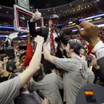 
Players lift Wisconsin head coach Bo Ryan after a regional final NCAA college basketball tournament game against Arizona, Saturday, March 29, 2014, in Anaheim, Calif. Wisconsin won 64-63 in overtime. (AP Photo/Jae C. Hong)