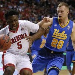 Arizona's Stanley Johnson, left, keeps the ball from UCLA's Bryce Alford during the second half of an NCAA college basketball game in the semifinals of the Pac-12 conference tournament Friday, March 13, 2015, in Las Vegas. Arizona defeated UCLA 70-64. (AP Photo/John Locher)