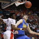 Arizona's Stanley Johnson, left, blocks a shot by UCLA's Gyorgy Goloman during the first half of an NCAA college basketball game in the semifinals of the Pac-12 conference tournament Friday, March 13, 2015, in Las Vegas. (AP Photo/John Locher)