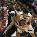 San Diego State forward Skylar Spencer, left, defends as Arizona forward Aaron Gordon grabs the ball during the first half of an NCAA men's college basketball tournament regional semifinal, Thursday, March 27, 2014, in Anaheim, Calif. (AP Photo/Jae C. Hong)