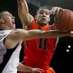Oregon State guard Malcolm Duvivier (11) blocks the shot by Arizona guard T.J. McConnell during the second half of an NCAA college basketball game, Friday, Jan. 30, 2015, in Tucson, Ariz. (AP Photo/Rick Scuteri)