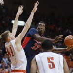 Arizona's Ronadae Hollis-Jefferson shoots in front of UTEP defenders Matt Wilms, left, and C.J. Cooper during the first half of an NCAA college basketball game Friday, Dec. 19, 2014, in El Paso, Texas. (AP Photo/Victor Calzada)