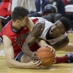 Arizona center Dusan Ristic, left, and UNLV center Goodluck Okonoboh fight for the ball during the first half of an NCAA college basketball game Tuesday, Dec. 23, 2014, in Las Vegas. (AP Photo/Eric Jamison)