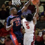 Arizona forward Rondae Hollis-Jefferson (23) tries to block a shot by Stanford guard Chasson Randle (5) during the first half of an NCAA college basketball game Thursday, Jan. 22, 2015, in Stanford, Calif. (AP Photo/Marcio Jose Sanchez)