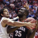 Gonzaga center Sam Dower, right, can't reach the basket as he is guarded by Arizona guard Elliott Pitts during the first half of a third-round game in the NCAA college basketball tournament Sunday, March 23, 2014, in San Diego. (AP Photo/Denis Poroy)