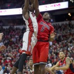 UNLV center Goodluck Okonoboh, left, drives to the basket while being guarded by Arizona forward Stanley Johnson (5) during the second half of an NCAA college basketball game Tuesday, Dec. 23, 2014, in Las Vegas. UNLV won 71-67. (AP Photo/Eric Jamison)
