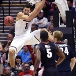Arizona forward Aaron Gordon hangs on the rim after dunking a basket while playing Gonzaga during the first half of a third-round game in the NCAA college basketball tournament Sunday, March 23, 2014, in San Diego. (AP Photo/Denis Poroy)