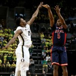 Arizona forward Stanley Johnson shoots over Oregon guard Jalil Abdul-Bassit during the first half of an NCAA college basketball game Thursday, Jan. 8, 2015, in Eugene, Ore. (AP Photo/Ryan Kang)