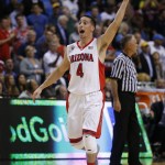Arizona's T.J. McConnell celebrates as his team leads UCLA near the end an NCAA college basketball game in the semifinals of the Pac-12 conference tournament Friday, March 13, 2015, in Las Vegas. Arizona defeated UCLA 70-64. (AP Photo/John Locher)