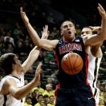 Arizona guard T.J. McConnell, center, loses control of the basketball during the first half of an NCAA college basketball game against Oregon on Thursday, Jan. 8, 2015m in Eugene, Ore. (AP Photo/Ryan Kang)