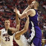 Weber State center Kyle Tresnak bowls over Arizona forward Aaron Gordon while shooting during the first half in a second-round game in the NCAA college basketball tournament Friday, March 21, 2014, in San Diego. (AP Photo/Denis Poroy)
