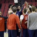 Arizona assistant coach Damon Stoudamire stands at left with the team as they huddle before practice for an NCAA college basketball second round game in Portland, Ore., Wednesday, March 18, 2015. Arizona plays Texas Southern on Thursday. (AP Photo/Don Ryan)

