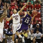 Weber State guard Davion Berry battles to get off a shot against the defense of Arizona guard Nick Johnson during the first half in a second-round game in the NCAA college basketball tournament Friday, March 21, 2014, in San Diego. (AP Photo/Gregory Bull)