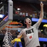 Wisconsin 's Frank Kaminsky cuts down the net after a regional final NCAA college basketball tournament game against Arizona, Saturday, March 29, 2014, in Anaheim, Calif. Wisconsin won 64-63 in overtime. (AP Photo/Jae C. Hong)