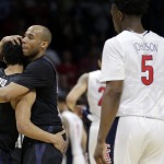 Xavier guard Myles Davis, second from left, hugs teammate guard Dee Davis, left, after losing to Arizona 68-60 in a college basketball regional semifinal in the NCAA Tournament, Thursday, March 26, 2015, in Los Angeles. (AP Photo/Jae C. Hong)