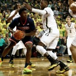 Arizona forward Stanley Johnson works between several Oregon defenders during the first half of an NCAA college basketball game Thursday, Jan. 8, 2015, in Eugene, Ore. (AP Photo/Ryan Kang)