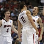 Arizona guard Gabe York, right, celebrates with T.J. McConnell (4) and Aaron Gordon (11) during the second half against San Diego State in a regional semifinal of the NCAA men's college basketball tournament, Thursday, March 27, 2014, in Anaheim, Calif. (AP Photo/Jae C. Hong)
