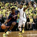 Arizona forward Stanley Johnson drives to the basket against Oregon guard Jalil Abdul-Bassit during the first half of an NCAA college basketball game Thursday, Jan. 8, 2015, in Eugene, Ore. (AP Photo/Ryan Kang)