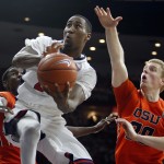 Arizona forward Rondae Hollis-Jefferson, middle, drives between Oregon State's Daniel Gomis, left, and Olaf Schaftenaar during the second half of an NCAA college basketball game, Friday, Jan. 30, 2015, in Tucson, Ariz. (AP Photo/Rick Scuteri)