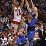 Arizona's Elliott Pitts shoots over UCLA's Bryce Alford, right, during the second half of an NCAA college basketball game in the semifinals of the Pac-12 conference tournament Friday, March 13, 2015, in Las Vegas. Arizona defeated UCLA 70-64. (AP Photo/John Locher)