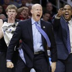 Xavier head coach Chris Mack, center, reacts during the first half of a college basketball regional semifinal against Arizona in the NCAA Tournament, Thursday, March 26, 2015, in Los Angeles. (AP Photo/Jae C. Hong)