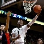 Oregon forward Jordan Bell, right, lays the ball up during the second half of an NCAA college basketball game against Arizona on Thursday, Jan. 8, 2015, in Eugene, Ore. (AP Photo/Ryan Kang)