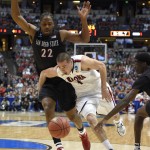 Arizona guard T.J. McConnell (4) drives past San Diego State forward Josh Davis (22) during the first half in a regional semifinal of the NCAA men's college basketball tournament, Thursday, March 27, 2014, in Anaheim, Calif. (AP Photo/Mark J. Terrill)