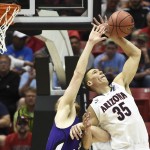 Arizona center Kaleb Tarczewski battles with Weber State center Kyle Tresnak for a rebound during the first half in a second-round game in the NCAA college basketball tournament Friday, March 21, 2014, in San Diego. (AP Photo/Denis Poroy)