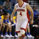 Arizona's T.J. McConnell celebrates after sinking a 3-point shot during the first half of an NCAA college basketball game in the semifinals of the Pac-12 conference tournament Friday, March 13, 2015, in Las Vegas. (AP Photo/John Locher)