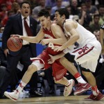 Wisconsin guard Bronson Koenig, left, drives past Arizona guard Elliott Pitts during the first half in a regional final NCAA college basketball tournament game, Saturday, March 29, 2014, in Anaheim, Calif. (AP Photo/Jae C. Hong)