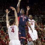 Arizona Wildcats forward Stanley Johnson (5) shoots between Stanford Cardinal center Stefan Nastic (4) and guard Marcus Allen (15) during the first half of an NCAA college basketball game Thursday, Jan. 22, 2015, in Stanford, Calif. (AP Photo/Marcio Jose Sanchez)