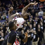 Washington's Mike Anderson, left, makes contact with Arizona's Rondae Hollis-Jefferson during the second half of an NCAA college basketball game Friday, Feb. 13, 2015, in Seattle. Arizona won 86-62. (AP Photo/Elaine Thompson)