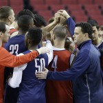 Arizona coach Sean Miller, front right, huddles with his team after practice for an NCAA college basketball second-round game in Portland, Ore., Wednesday, March 18, 2015. Arizona is to play Texas Southern on Thursday. (AP Photo/Don Ryan)