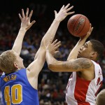 Arizona's Brandon Ashley, right, shoots over UCLA's Thomas Welsh during the second half of an NCAA college basketball game in the semifinals of the Pac-12 conference tournament Friday, March 13, 2015, in Las Vegas. Arizona defeated UCLA 70-64. (AP Photo/John Locher)