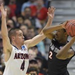San Diego State guard Xavier Thames (2) looks to pass around Arizona guard T.J. McConnell (4) during the first half in a regional semifinal of the NCAA men's college basketball tournament, Thursday, March 27, 2014, in Anaheim, Calif. (AP Photo/Mark J. Terrill)