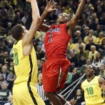 Arizona's Mark Lyons (2) shoots between Oregon's Waverly Austin, left, and Johnathan Loyd (10) during the first half of their NCAA college basketball game, Thursday, Jan. 10, 2013, in Eugene, Ore. (AP Photo/Chris Pietsch)