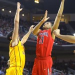 Arizona forward Brandon Ashley, right, puts up a shot as Southern California center Omar Oraby defends during the first half of an NCAA college basketball game, Sunday, Jan. 12, 2014, in Los Angeles. (AP Photo/Mark J. Terrill)