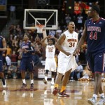 Southern California's Eric Wise (34) celebrates as Arizona's Solomon Hill (44) walks past during the final seconds of an NCAA college basketball game in Los Angeles, Wednesday, Feb. 27, 2013. USC won 89-78. (AP Photo/Jae C. Hong)