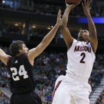 Arizona's Mark Lyons shoots over Harvard's Jonah Travis in the second half during a third-round game in the NCAA men's college basketball tournament in Salt Lake City Saturday, March 23, 2013. Arizona defeated Harvard 74-51. (AP Photo/George Frey)
