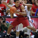 Stanford's Josh Huestis, in front, maneuvers against Arizona's Nick Johnson, back, for a shot in the second half of an NCAA college basketball game Sunday, March 2, 2014, in Tucson, Ariz. Arizona won 79-66. (AP Photo/John MIller)