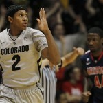 Colorado forward Xavier Johnson, front, reacts after hitting a three-point basket as Arizona forward Solomon Hill looks on in the first half of an NCAA college basketball game in Boulder, Colo., Thursday, Feb. 14, 2013. (AP Photo/David Zalubowski)