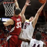 Arizona's Kaleb Tarczewski (35) grabs the rebound from Stanford's Dwight Powell (33) as Arizona's Solomon Hill watches during the first half of an NCAA college basketball game at McKale Center in Tucson, Ariz., Wednesday, Feb. 6, 2013. (AP Photo/Wily Low)