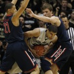 Colorado forward Josh Scott, center, is trapped in the corner with the ball by Arizona forward Brandon Ashley, left, and center Kaleb Tarczewski in the first half of an NCAA college basketball game in Boulder, Colo., Thursday, Feb. 14, 2013. (AP Photo/David Zalubowski)